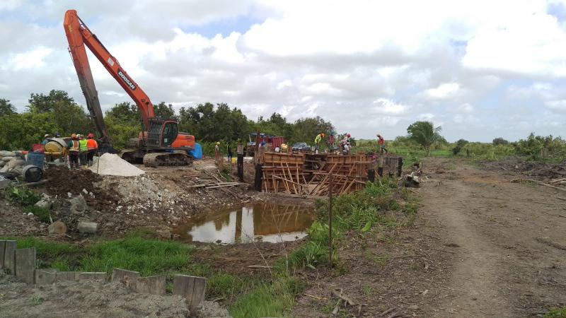 Work ongoing on a structure along an irrigation channel.